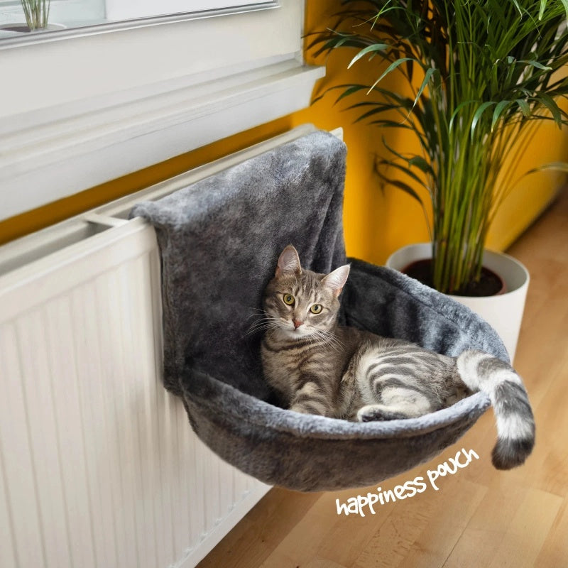 grey velour cat bed, soft texture, natural light, beside potted plant, warm yellow wall