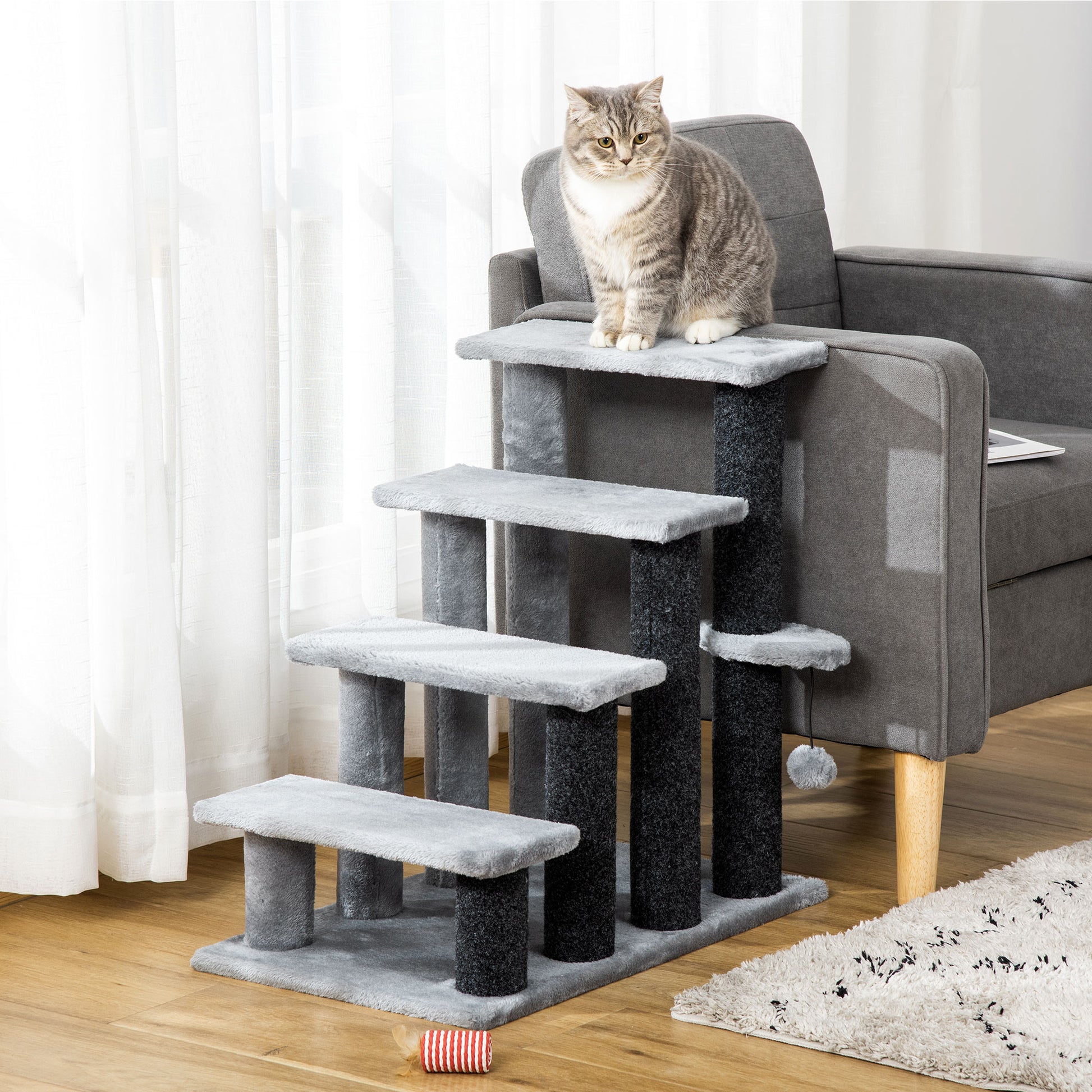 velour cat tree, soft grey platforms, natural light, beside grey armchair